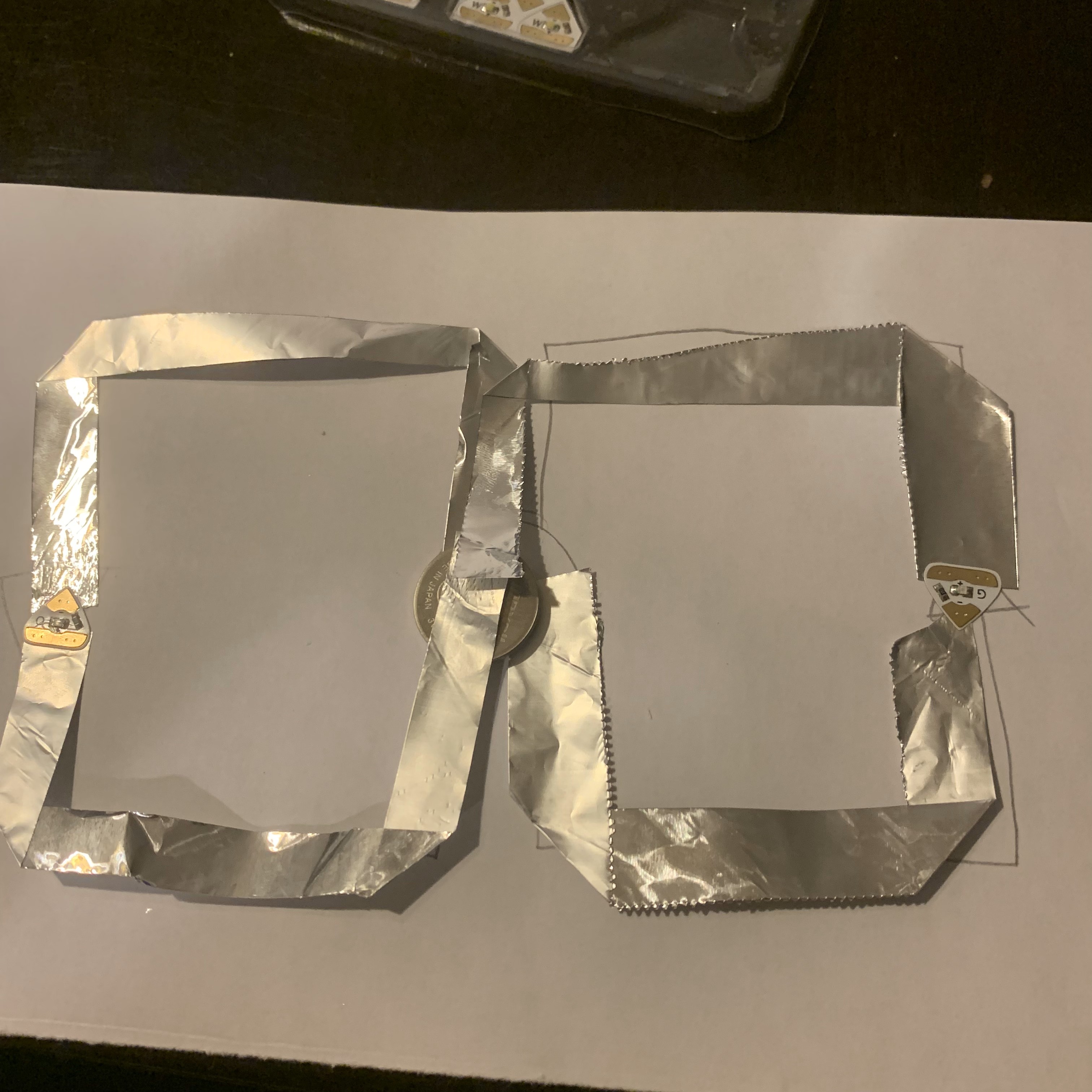 Cut out the strips of Aluminium Foil and placed them accordingly to the sketch, Stuck the LED Lights in their spots, and placed the Battery in the correct spot.