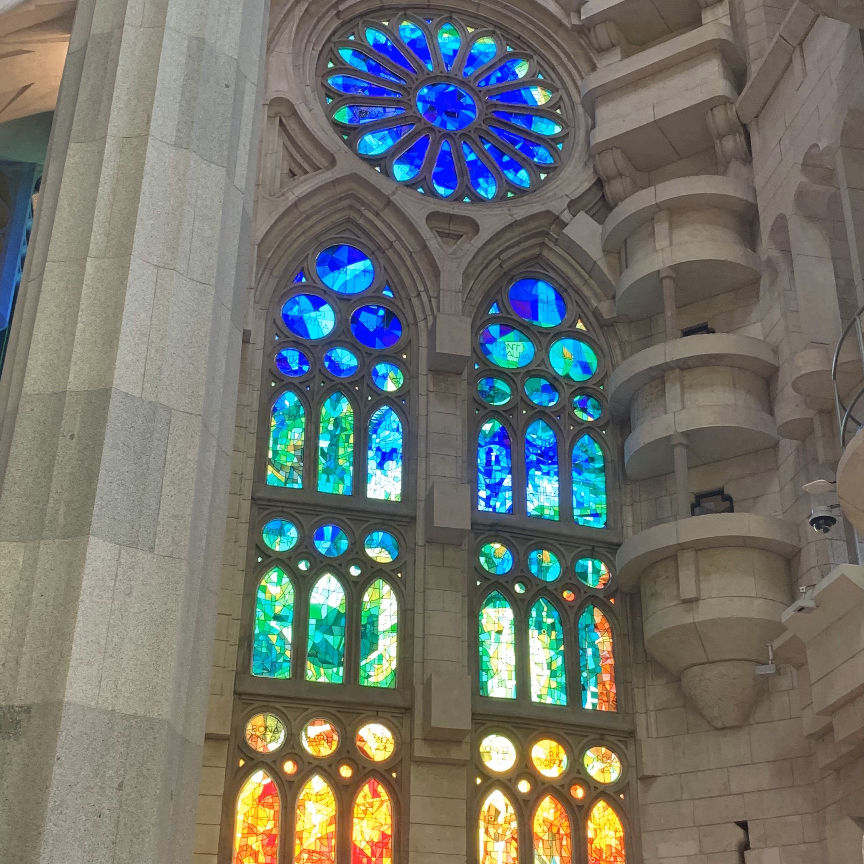 Carefully crafted mosaic glass off to the side via the inside the Basílica de la Sagrada Família.